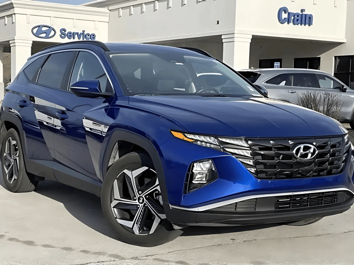 Blue used Hyundai Tucson SUV parked outside Crain Hyundai of Bentonville, showcasing affordable used SUV options under $25K in Bentonville, Arkansas.