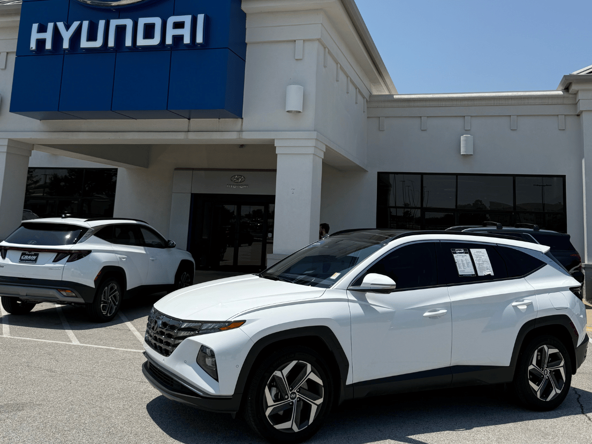 2025 Hyundai Tucson Hybrid parked outside Crain Hyundai of Bentonville dealership under clear blue sky