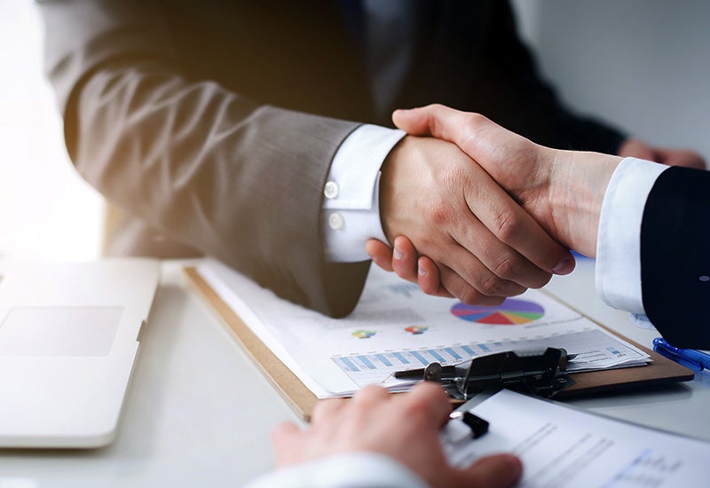 two business mean shaking hands in a deal